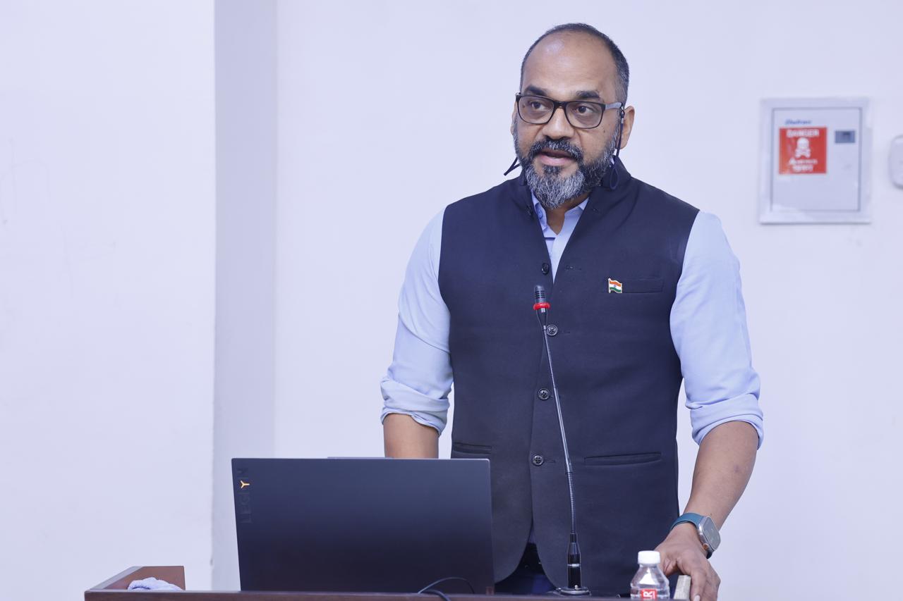 Vijay Sharma speaking at podium